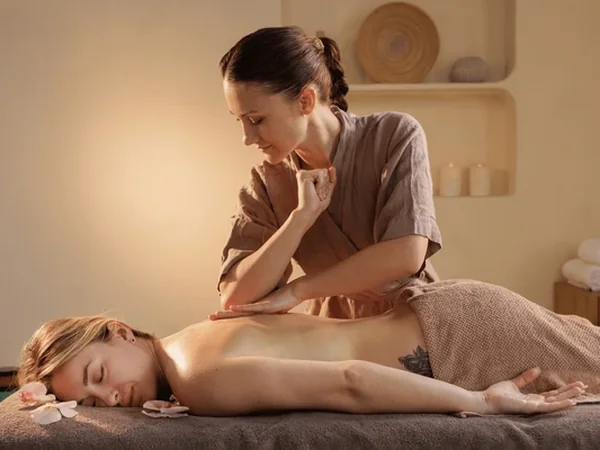 A registered massage therapist working on a client at Sunshine Wellness in Oakville